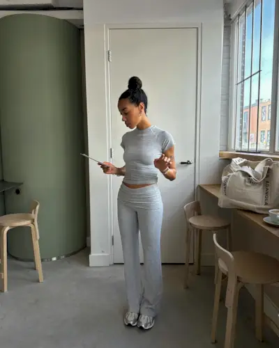 @amaka.hamelijnck wearing trainers with grey leggings and top