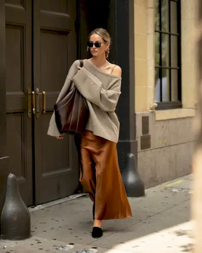 woman in sweater and silk skirt