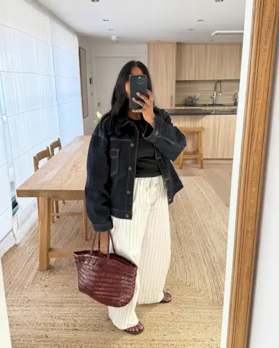 An image of @monikh wearing a woven leather bag.