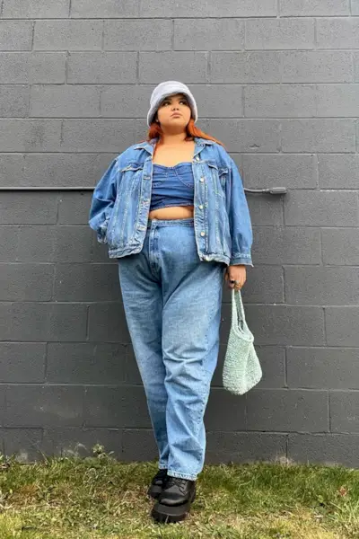 a woman's corset top outfit with a jean bustier styled with a matching jacket and jeans and combat boots