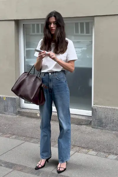 a photo showing what shoes to wear with bootcut jeans, specifically a woman wearing