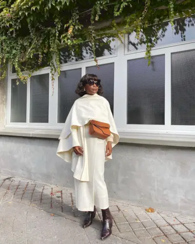 Boot Trends 2024: @frannfyne wears a pair of burgundy boots with a cream outfit