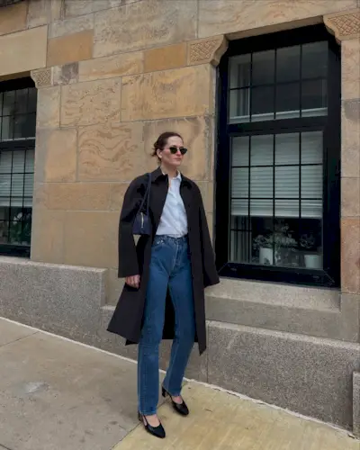 Eliza Huber wearing a brown FFORME car coat with a white button-down shirt, Levi's jeans, and Chanel sling-backs.