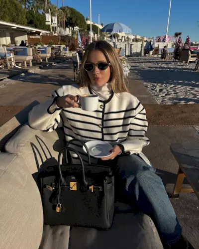 Influencer wears a striped cardigan.