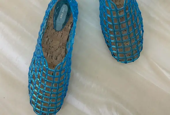 a pair of blue Mara jelly flats from The Row