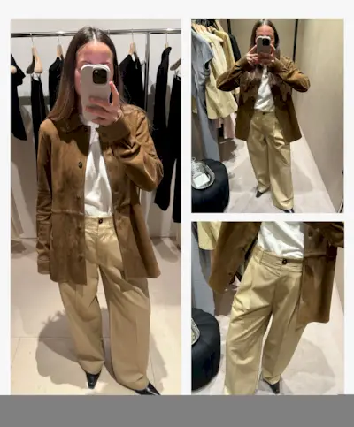Woman takes photo in changing room mirror wearing suede shirt, white t-shirt and chino wide-leg trousers from Toteme.