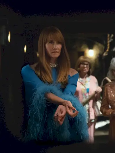 Laura Dern wears a feathery blue dress in Palm Royale fashion