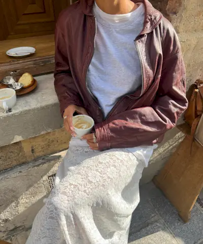 Influencer wears a burgundy leather jacket