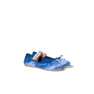 Elsa Hosk wears pink satin ballet flats with a satin two-piece and a pink bag.