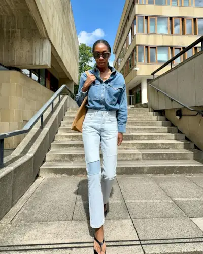 woman wearing slim jeans and denim button-down shirt