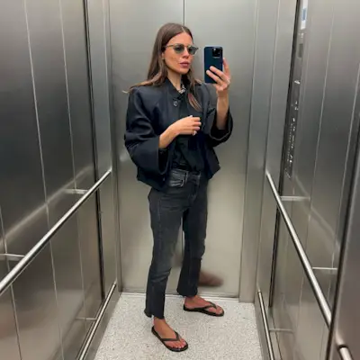 woman wearing black slim jeans and flip flops