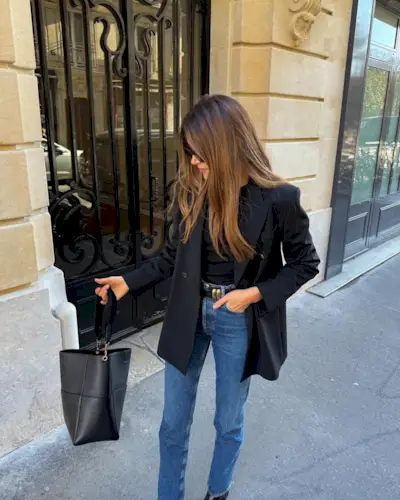 woman wearing slim jeans and black blazer