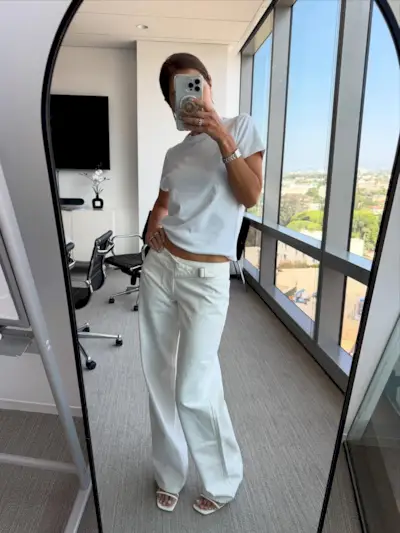 Woman in white low rise jeans and t-shirt