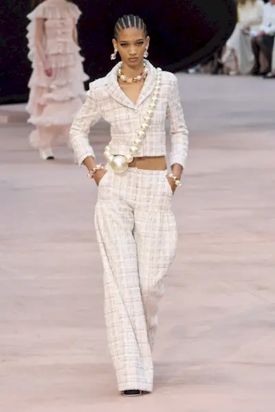 Woman on Chanel runway wearing low-rise tweed pants