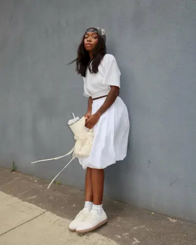 Woman wearing knee-length skirt outfit summer 2025.