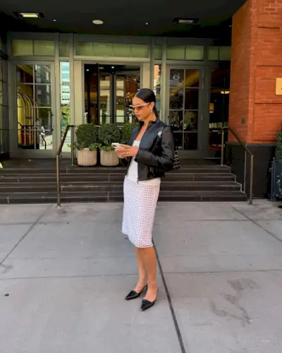 Woman wearing knee-length skirt outfit summer 2025.