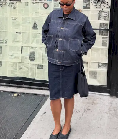 Woman wearing knee-length skirt outfit summer 2025.