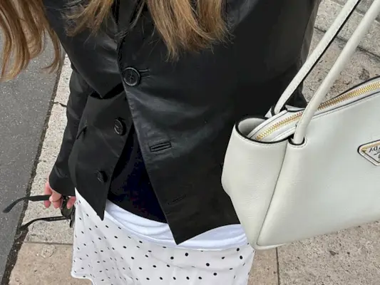 Woman wearing knee-length skirt outfit summer 2025.