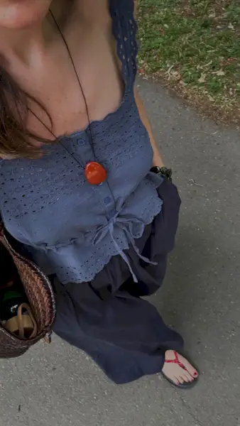 An image of @francescasaffari wearing a navy blue broderie anglaise top, one of the key summer tops trends of 2025.