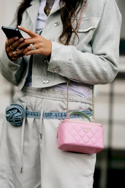 most popular chanel bags shown in a street style photo of a woman carrying a chanel vanity case bag
