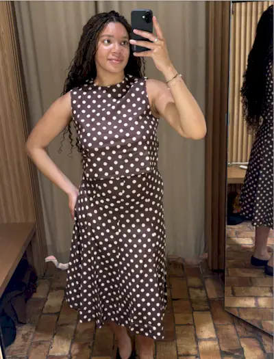 Addison Rae attends the Miu Miu spring/summer 2025 show on a polka dot two piece set, Miu Miu bag and shoes.