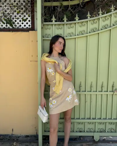@livvperez wearing an embroidered linen mini dress