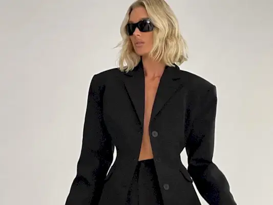 fitted waist blazers trend shown on a woman wearing a black blazer