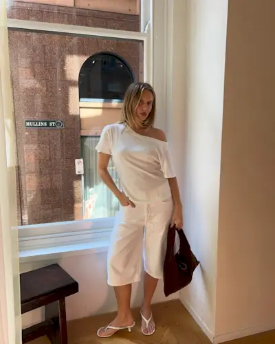 Woman wearing fall brown suede bag trend.