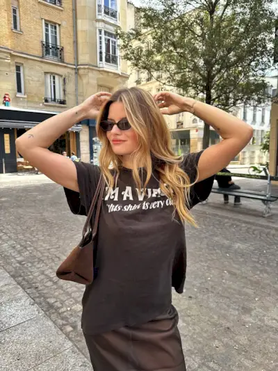 Woman wearing fall brown suede bag trend.