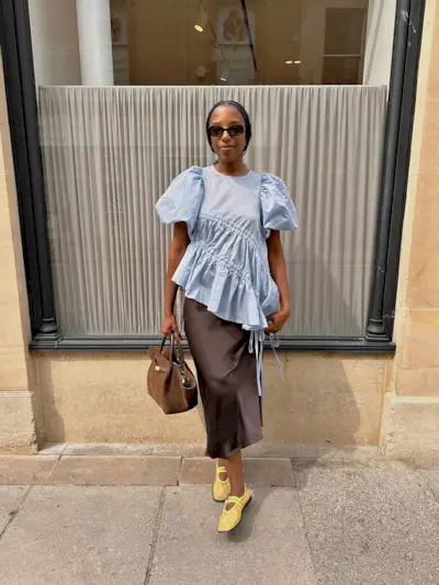 Woman wearing fall brown suede bag trend.