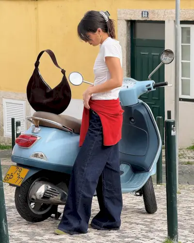 Woman wearing fall brown suede bag trend.
