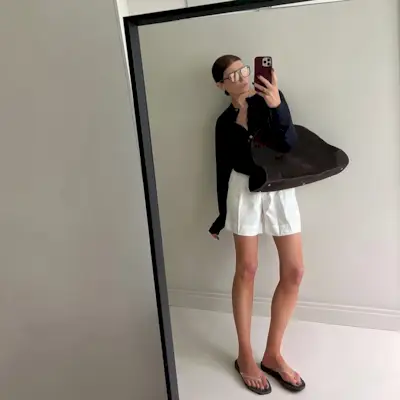 Woman wearing fall brown suede bag trend.