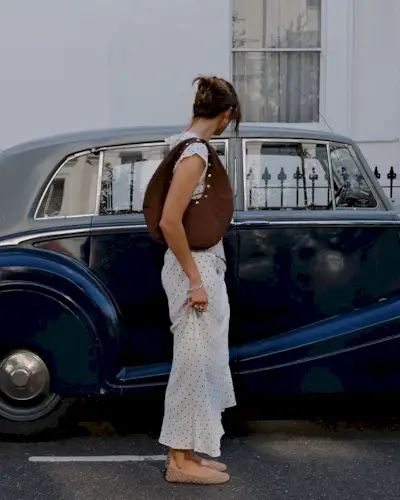 Woman wearing fall brown suede bag trend.
