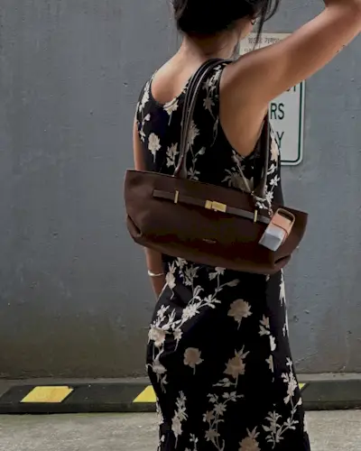 Woman wearing fall brown suede bag trend.