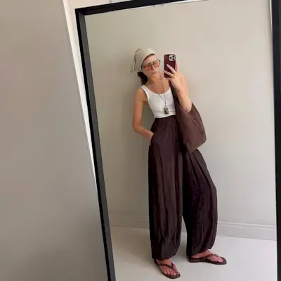 Woman wearing fall brown suede bag trend.