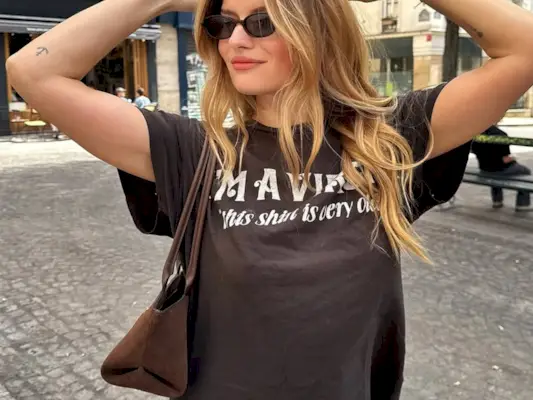 Woman wearing fall brown suede bag trend.