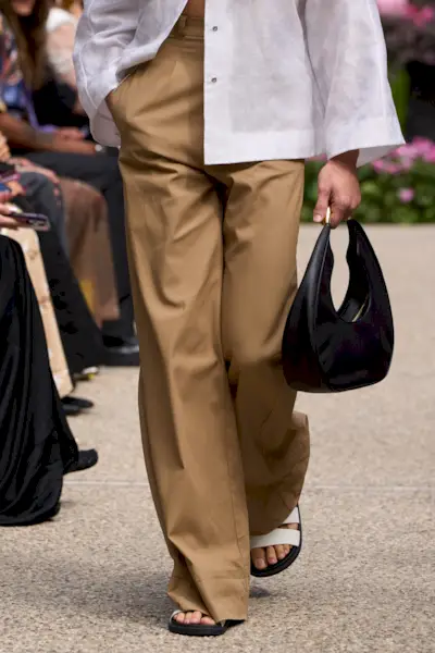 Model walking in the Sarawong S/S 25 show wearing chinos.