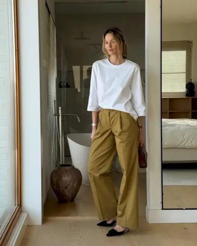 Anouk wears elevated chinos and a white top.