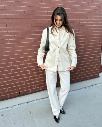 An influencer wearing an all-white outfit.