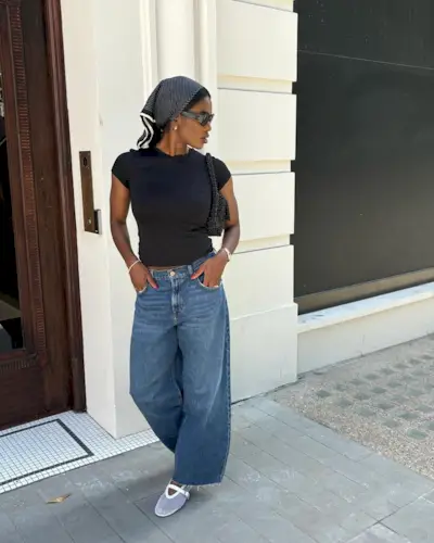 An influencer wearing jeans and a shirt.