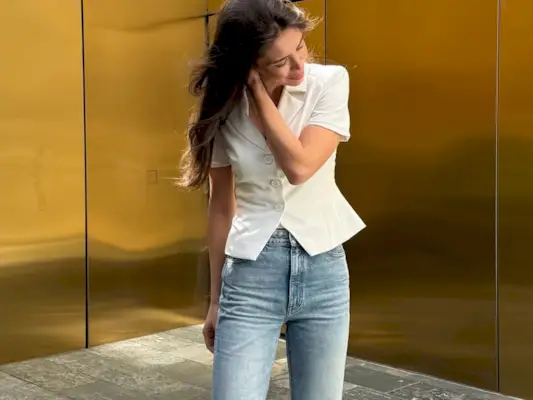 Woman wearing jeans with pointed peep-toe heels in 2025.