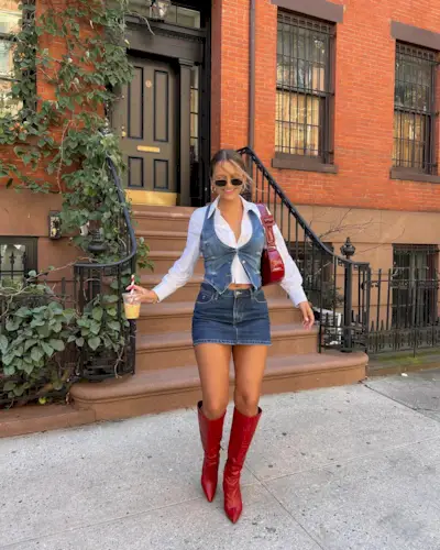 Woman wearing denim and red boots.