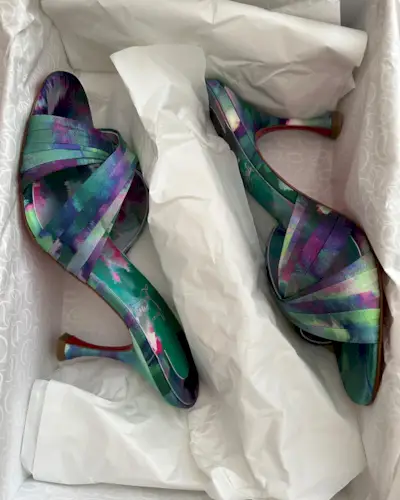 a photo showing cocktail attire for women with a close photo of blue heels in a box