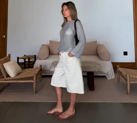 An influencer wearing clear flip flops.