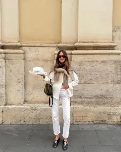 French influencer wearing a cardigan and cream jeans
