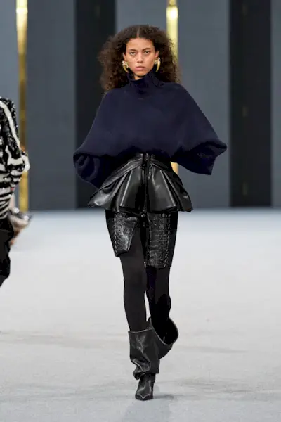 A model wears slouchy boots on Balmain's autumn/winter 2025 runway