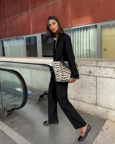 French fashion influencer Salome Mory wearing a chic fall outfit with black pants in Paris.