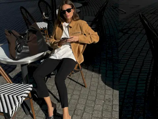 French fashion influencer Anne-Laure Mais in Paris wearing a chic fall outfit with black pants.