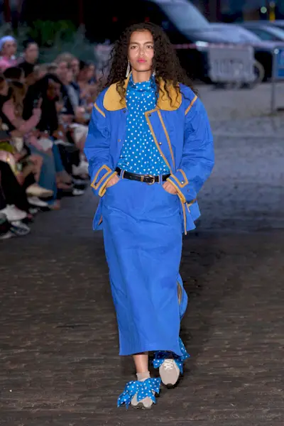 Woman wearing cobalt blue dress during Copenhagen Fashion Week.