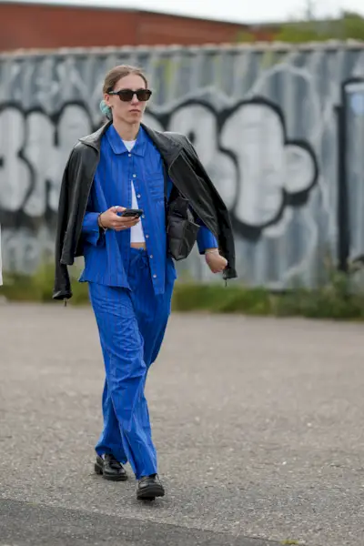 Woman wearing cobalt blue jeans and shirt during Copenhagen Fashion Week.